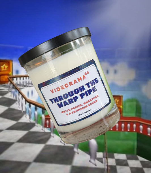 Videorama64 "Through the Warp Pipe" Mario-inspired soy candle, 10 oz, white peach and sweetpea scent, glitch label, Super Mario 64 castle background
