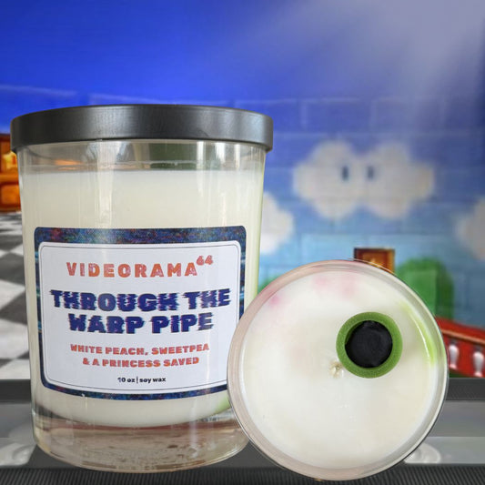 Videorama64 "Through the Warp Pipe" candle with lid showing green warp pipe wax embed, Mario-themed pop culture soy candle, 10 oz